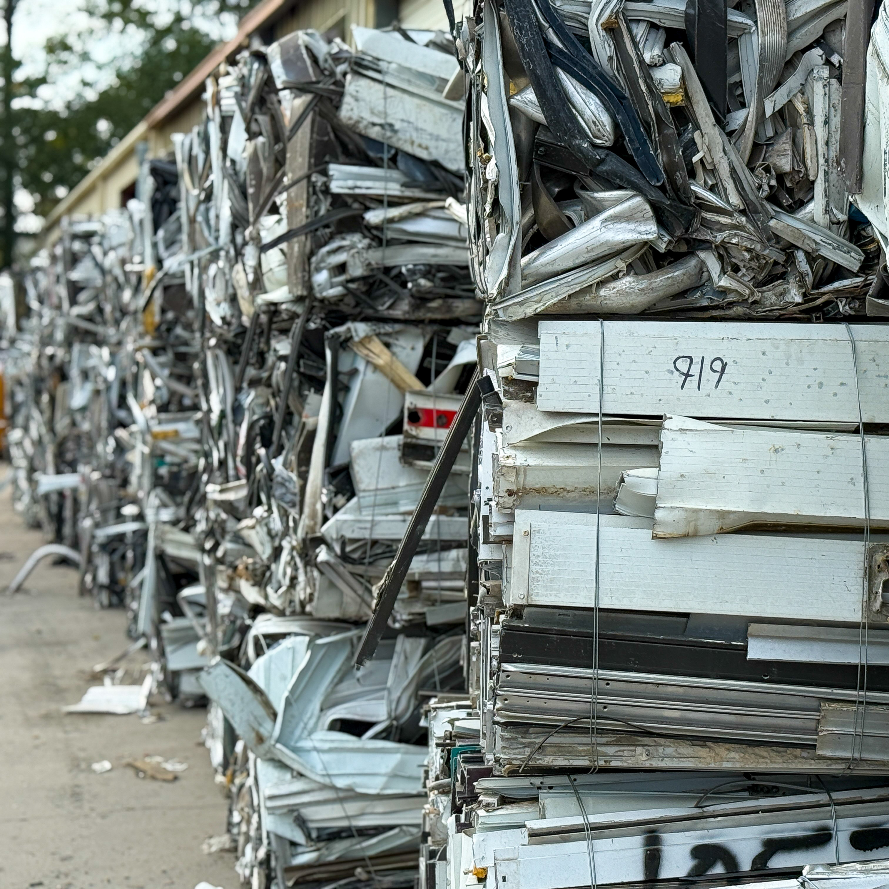 Baled scrap metal stacked in Jacksonville Metal Recycling yard